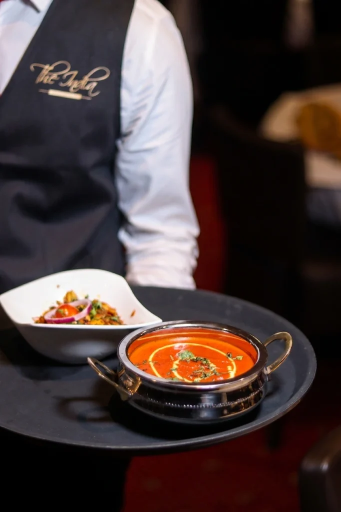 Creamy tomato curry served in a kadai bowl at The India restaurant
